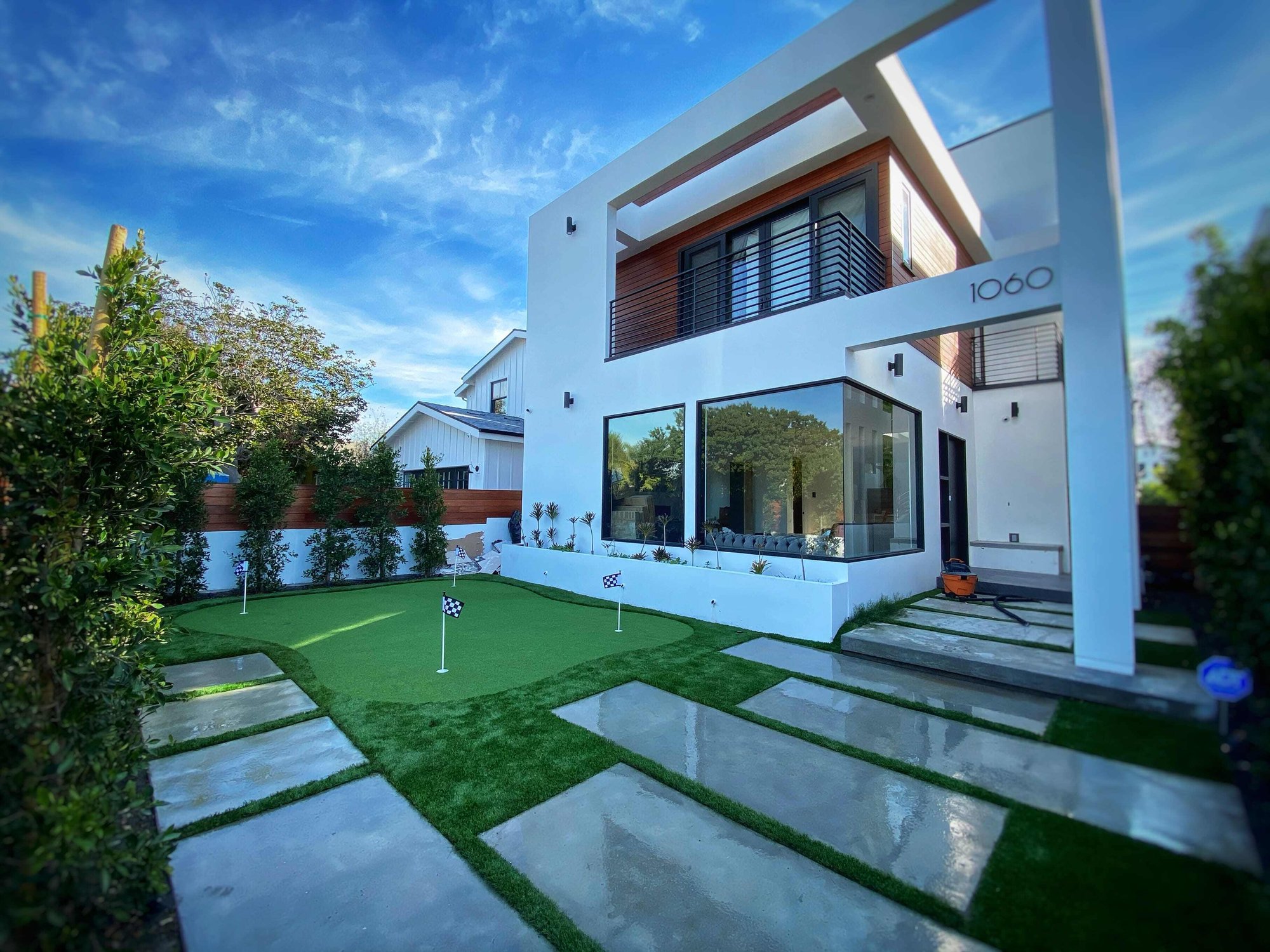 modern house with a putting green golf court